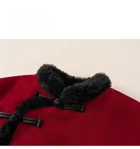 Detail of red wool fabric with black faux fur collar and traditional frog button closure