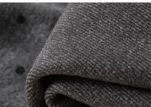 Macro view of dark grey thick knitted fabric texture and soft thermal material details