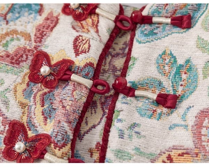 Detail of traditional Chinese jacquard fabric with handmade red butterfly knot and pearls