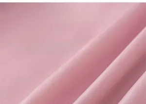 Close-up of pink silk texture with soft folds on a thickened winter hooded coat