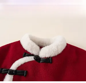 Close-up of red woolen kids festive top featuring plush collar and Chinese frog buttons