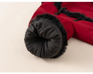 Close-up of winter coat sleeve with thick red fabric and plush black faux fur lining