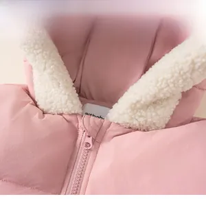 Detail of pink hooded winter jacket showing soft white fleece lining and smooth zipper