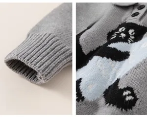 Detail of grey knitted kids sweater with cartoon cat pattern and ribbed cuffs