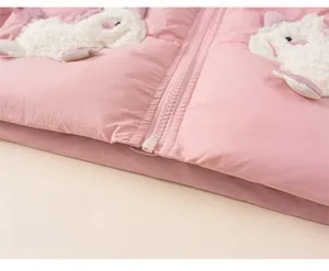 Close-up of pink children's puffer jacket with cute lamb fleece appliques and zipper