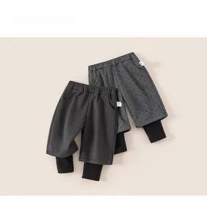 Detail view of thick kids casual trousers with layered cuffs and elastic waistband