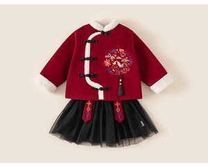 Detail of red velvet Chinese New Year top with embroidery and black tulle skirt