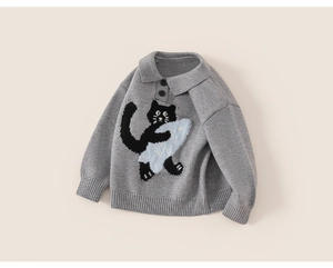 Detail of grey knitted children's polo sweater featuring a cute cartoon cat pattern
