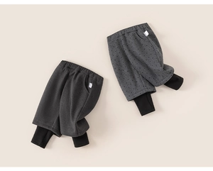 Detail of dark grey fleece-lined layered leggings with elastic waist and mini side label