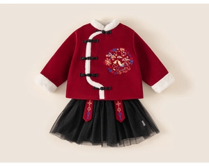 Detail of red Chinese style girls' top with faux fur trim and black mesh tutu skirt
