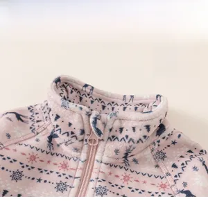 Detail of children's pink fleece jacket with classic stand collar and winter elk pattern