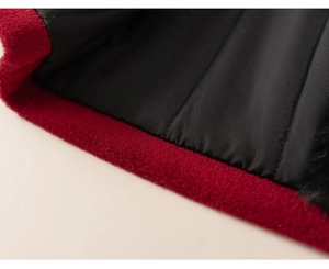 Macro detail of dark red faux fur fabric and smooth black lining on winter jacket
