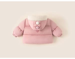 Detail of pink toddler winter coat featuring 3D dinosaur crests on the hood and fleece lining