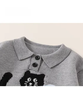Close-up of children's grey knit polo sweater with cartoon cat jacquard and buttons