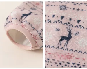 Detail of pink fleece kid jacket with snowflake reindeer patterns and elastic cuffs