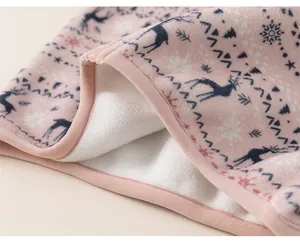 Detail of pink fleece winter coat showing Nordic deer print and white faux shearling lining