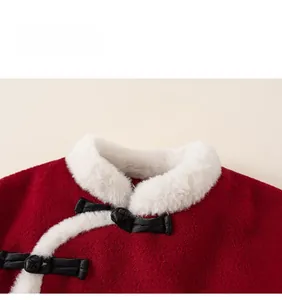 Detail of red winter cape with white faux fur collar and traditional black frog button