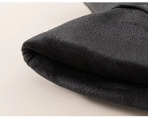 Detail shot of the thick black velvet fabric with premium satin piping on winter trousers