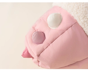 Detail of pink quilted girls winter coat featuring white fleece trim and colorful dot patches