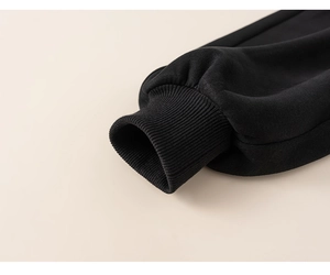 Detail of black ribbed elastic cuffs on winter thermal two-piece set for boys