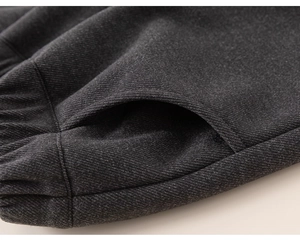 Detailed close-up of dark grey thick twill fabric with elastic waist and side pocket