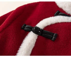 Detail of red festive top with traditional Chinese frog button and white faux fur trim