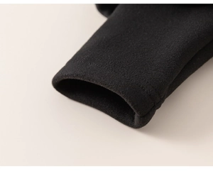 Macro shot of plush black knit fabric cuff showing soft texture and premium stitching