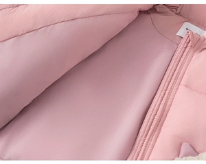 Detailed macro view of the soft pink inner lining and smooth zipper on a warm padded coat