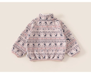 Detail of soft pink fleece jacket with festive reindeer and snowflake Fair Isle patterns