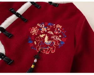 Detail of red Chinese New Year kids top with horse embroidery and traditional knots