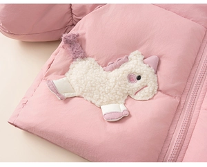 Close-up of pink quilted puffer jacket with white unicorn embroidery and purple tail detail
