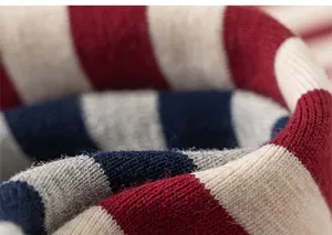 Close-up of thick ribbed knit cuffs featuring red, cream, and navy blue horizontal stripes