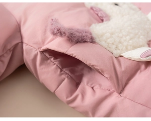 Detailed view of pink padded jacket featuring a 3D plush sheep animal on the pocket