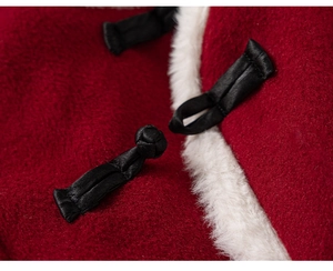 Macro detail of red wool fabric with black frog button and white faux fur collar trim