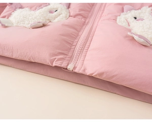 Detail of pink winter coat featuring cute lamb wool animal appliques and smooth zipper