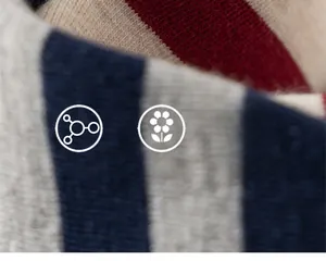 Detailed macro view of soft knit striped fabric in red, beige, and blue for kids apparel
