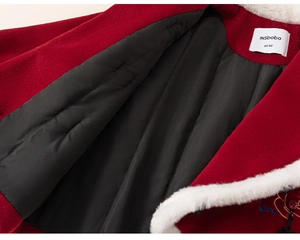 Detail of red winter jacket with faux fur collar and quilted lining for girls