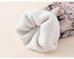 Detail of warm pink fleece winter fabric with navy elk patterns and white inner lining