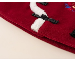 Detailed macro view of red wool fabric with faux fur collar and traditional frog button