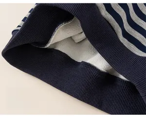 Detail view of thickened fleece lining and elastic ribbed hem on striped kids sweatshirt