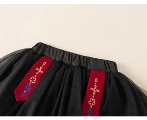 Detailed view of kids' Chinese New Year skirt with black tulle and floral embroidery