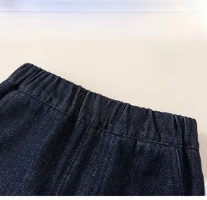 Close-up of kids denim pants featuring an elastic waistband and premium twill fabric