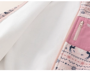 Detail of Nordic reindeer pattern on pink fleece coat with soft white sherpa lining