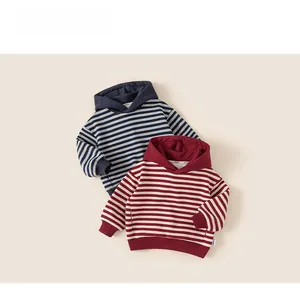 Flat lay detail of striped hooded sweatshirts for kids in navy blue and burgundy colors