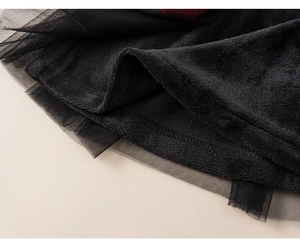 Detail of red and black tulle skirt with thick plush lining for girls' New Year clothes