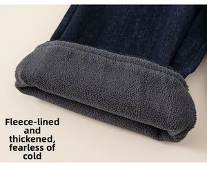 Macro shot showing the thick grey fleece lining inside the dark blue denim jeans