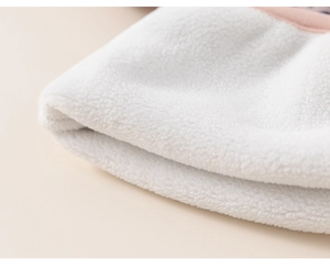 Close-up of soft white coral fleece fabric showing premium plush texture for winter clothing