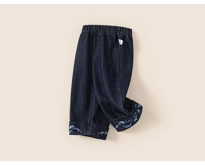 Close-up of kids navy denim jeans with wave embroidery and elastic waist