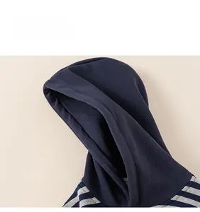 Detail showing the dark blue hooded design and grey striped pattern on a kids sweater