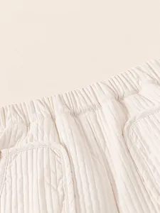Pantalon d'hiver matelassé pour enfant en blanc crème avec taille élastique et poches